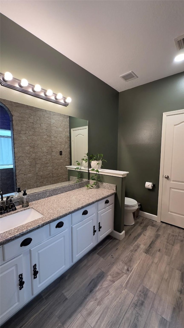 6514 Evening Rose Ln, Katy, TX 77449 - bathroom featuring toilet, wood finished floors, vanity, and baseboards