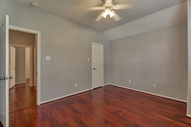 empty room featuring ceiling fan, a smoke detector, wood finished floors, baseboards, and lofted ceiling