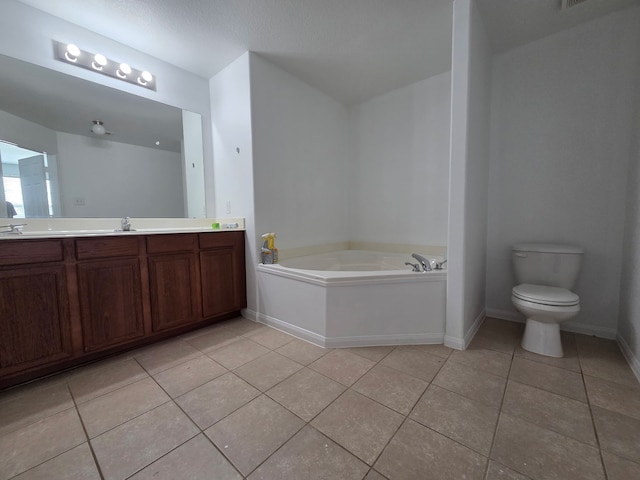 9914 Pearl Creek Ln, Rosharon, TX 77583 - bathroom with tile patterned flooring, a garden tub, baseboards, vanity, and toilet
