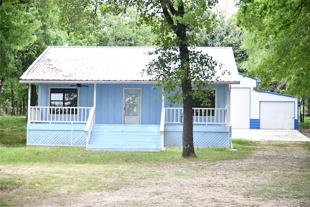 112 Lcr 902, Jewett, TX 75846 - bungalow-style home with covered porch, an outdoor structure, board and batten siding, a garage, and dirt driveway
