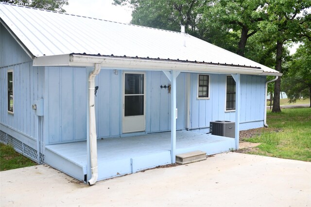 112 Lcr 902, Jewett, TX 75846 - rear view of property featuring board and batten siding, a patio area, and central AC