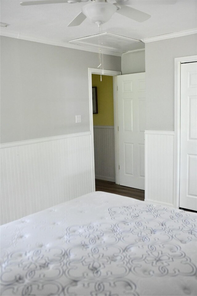 112 Lcr 902, Jewett, TX 75846 - unfurnished bedroom with wainscoting, crown molding, a closet, dark wood finished floors, and ceiling fan