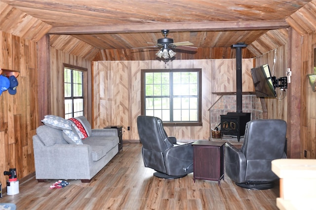 112 Lcr 902, Jewett, TX 75846 - living area featuring wooden walls, a wood stove, wooden ceiling, wood finished floors, and healthy amount of natural light