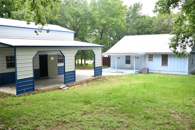 112 Lcr 902, Jewett, TX 75846 - rear view of property with a lawn, metal roof, board and batten siding, a patio, and central air condition unit