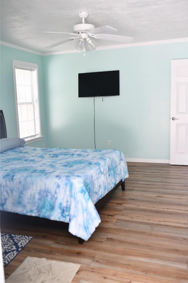 112 Lcr 902, Jewett, TX 75846 - bedroom featuring crown molding, wood finished floors, a textured ceiling, ceiling fan, and baseboards
