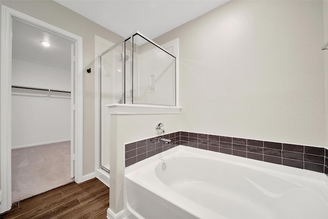 23431 Wrexham St, Spring, TX 77373 - bathroom featuring a stall shower, a spacious closet, wood finished floors, and a bath