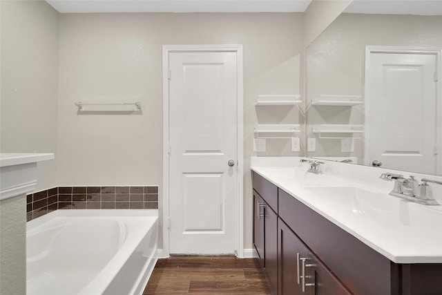 23431 Wrexham St, Spring, TX 77373 - bathroom with wood finished floors, a bath, and double vanity