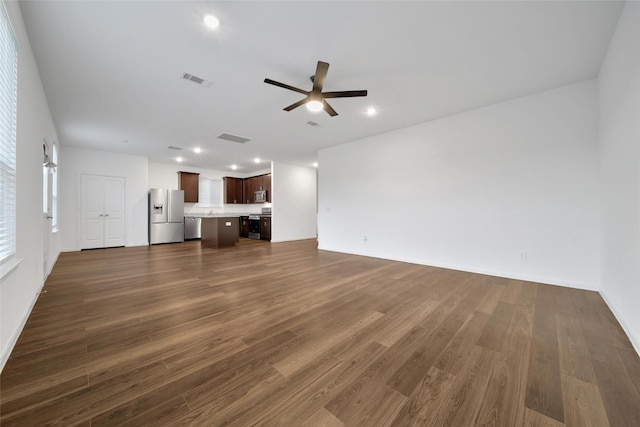 23431 Wrexham St, Spring, TX 77373 - unfurnished living room featuring a ceiling fan, dark wood-style flooring, recessed lighting, and baseboards