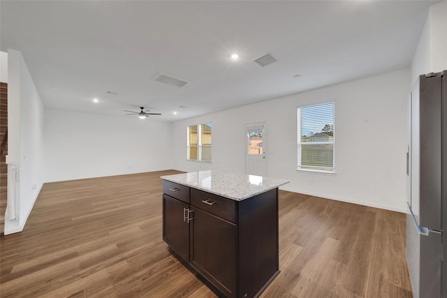23431 Wrexham St, Spring, TX 77373 - kitchen featuring freestanding refrigerator, ceiling fan, wood finished floors, a kitchen island, and recessed lighting