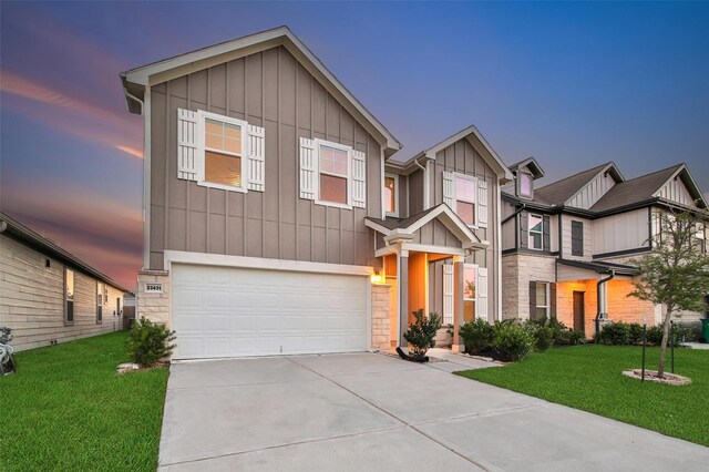 23431 Wrexham St, Spring, TX 77373 - view of front facade with board and batten siding, stone siding, a garage, and concrete driveway