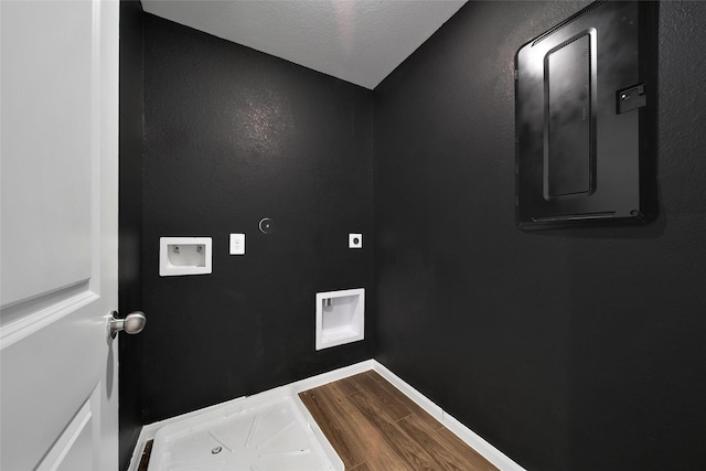 23431 Wrexham St, Spring, TX 77373 - laundry view of wood finished floors, baseboards, and electric panel