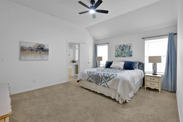bedroom with light colored carpet, lofted ceiling, baseboards, ensuite bath, and ceiling fan