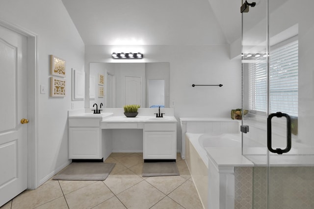 bathroom featuring tile patterned flooring, double vanity, a garden tub, vaulted ceiling, and a stall shower
