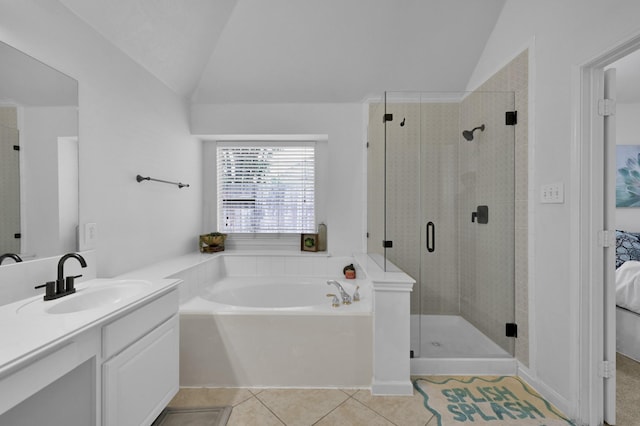 full bath featuring lofted ceiling, tile patterned floors, a shower stall, vanity, and ensuite bathroom
