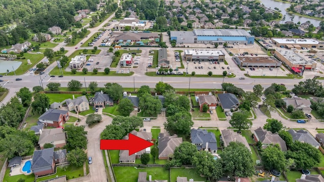 aerial view of property's location featuring a large body of water and nearby suburban area