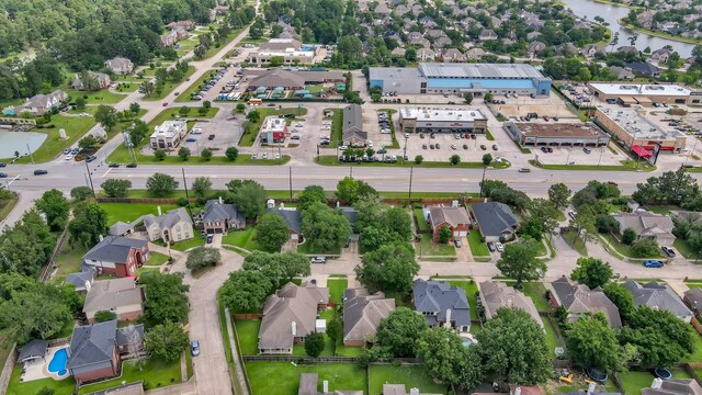 aerial view of property's location with nearby suburban area and a nearby body of water