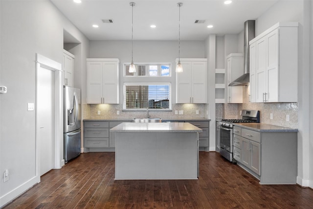kitchen featuring appliances with stainless steel finishes, open shelves, a sink, wall chimney exhaust hood, and backsplash