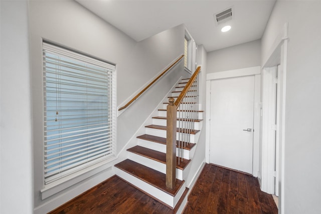 stairway with wood-type flooring, baseboards, and recessed lighting