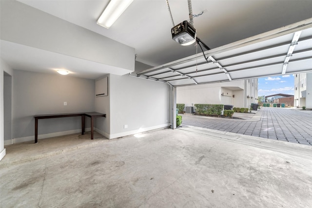 garage featuring a garage door opener and baseboards