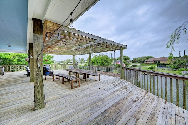 deck featuring a pergola and outdoor dining area