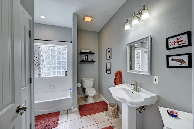 full bathroom featuring toilet, tile patterned flooring, and baseboards