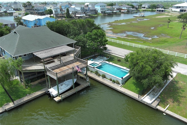 aerial perspective of suburban area with a nearby body of water and a pool