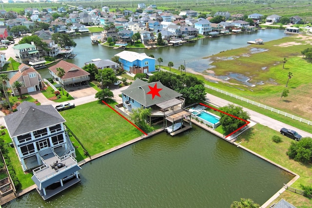 aerial view of residential area featuring property boundaries highlighted and a nearby body of water