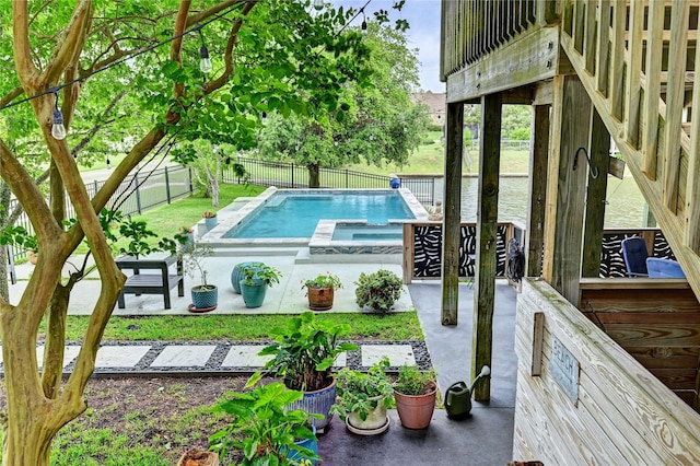 view of swimming pool featuring an in-ground hot tub and a fenced backyard