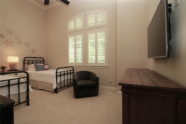 bedroom featuring carpet flooring, ornamental molding, baseboards, and a ceiling fan