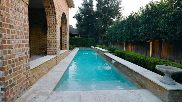 view of swimming pool with fence