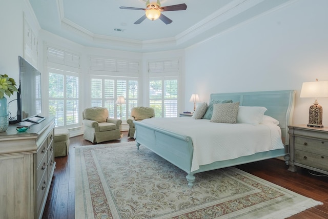 34 S Taylor Point Dr, The Woodlands, TX 77382 - bedroom with multiple windows, dark wood-type flooring, a raised ceiling, and ornamental molding