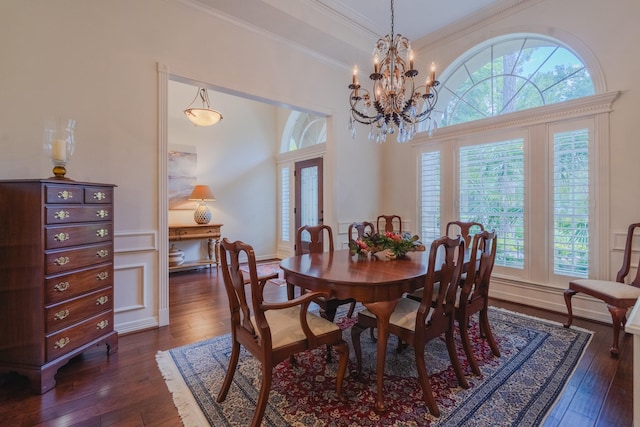 34 S Taylor Point Dr, The Woodlands, TX 77382 - dining area featuring dark wood-style flooring, crown molding, and a chandelier