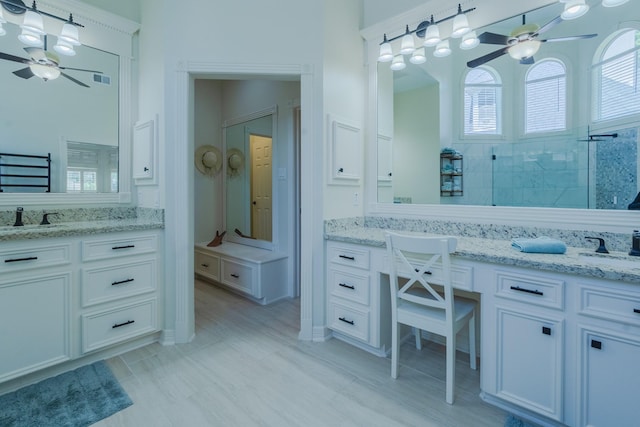 34 S Taylor Point Dr, The Woodlands, TX 77382 - full bathroom with ceiling fan, two vanities, and walk in shower
