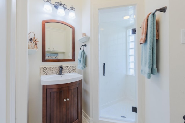 34 S Taylor Point Dr, The Woodlands, TX 77382 - bathroom featuring a stall shower, vanity, and backsplash