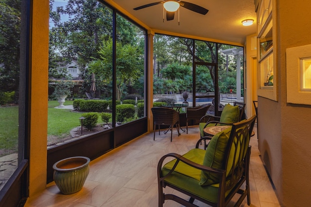 34 S Taylor Point Dr, The Woodlands, TX 77382 - sunroom / solarium featuring ceiling fan, healthy amount of natural light, floor to ceiling windows, a textured wall, and outdoor dining space