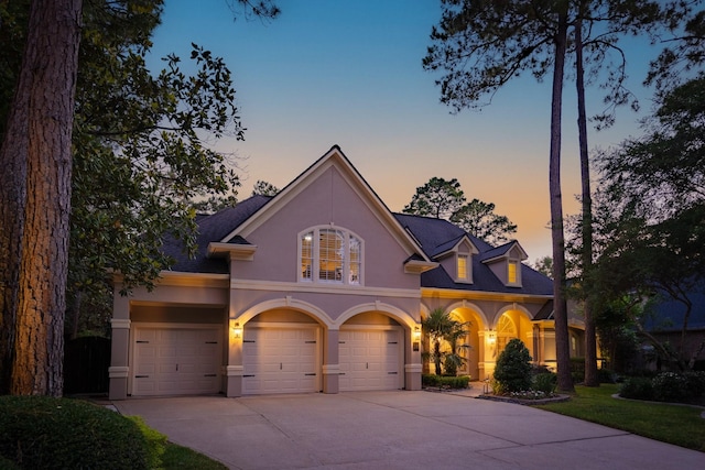34 S Taylor Point Dr, The Woodlands, TX 77382 - view of front of property with stucco siding, concrete driveway, and an attached garage