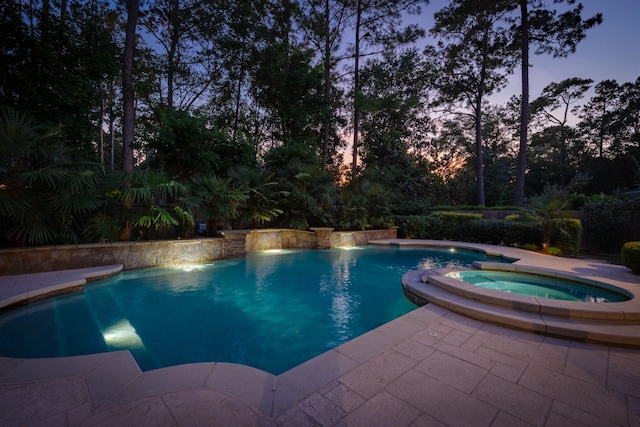34 S Taylor Point Dr, The Woodlands, TX 77382 - pool at dusk featuring a pool with connected hot tub