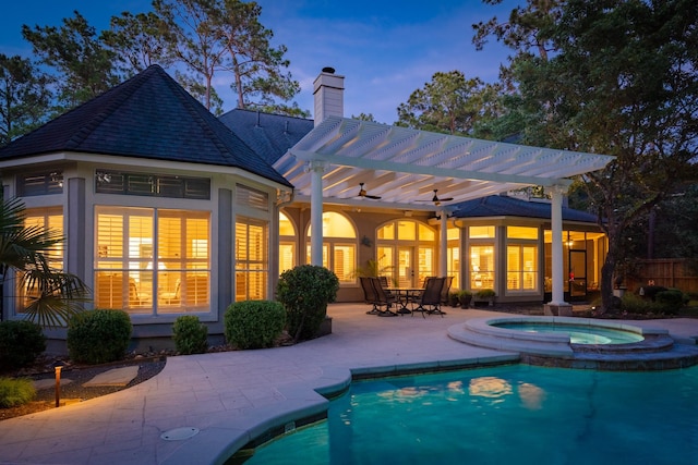 34 S Taylor Point Dr, The Woodlands, TX 77382 - back of property with an in-ground hot tub, a pergola, a chimney, and an outdoor pool