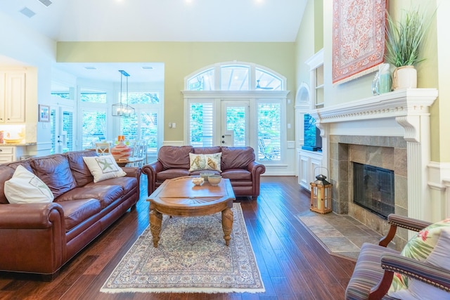 34 S Taylor Point Dr, The Woodlands, TX 77382 - living room featuring dark wood-type flooring, a tiled fireplace, a high ceiling, a chandelier, and recessed lighting