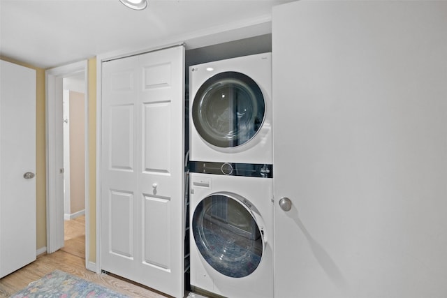 79 Lakeview Vlg, Conroe, TX 77356 - clothes washing area featuring stacked washer and clothes dryer, wood finished floors, and baseboards