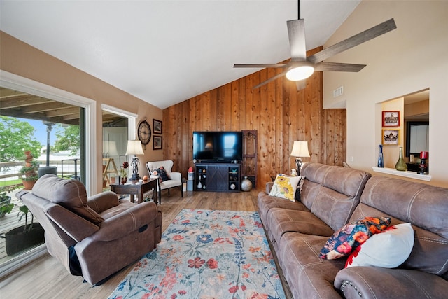 79 Lakeview Vlg, Conroe, TX 77356 - living room with wooden walls, wood finished floors, high vaulted ceiling, and a ceiling fan