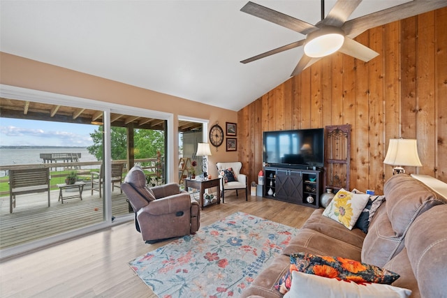 79 Lakeview Vlg, Conroe, TX 77356 - living area with wood walls, ceiling fan, wood finished floors, and high vaulted ceiling