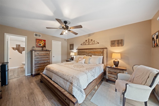 79 Lakeview Vlg, Conroe, TX 77356 - bedroom featuring wood finished floors, baseboards, a ceiling fan, and ensuite bathroom