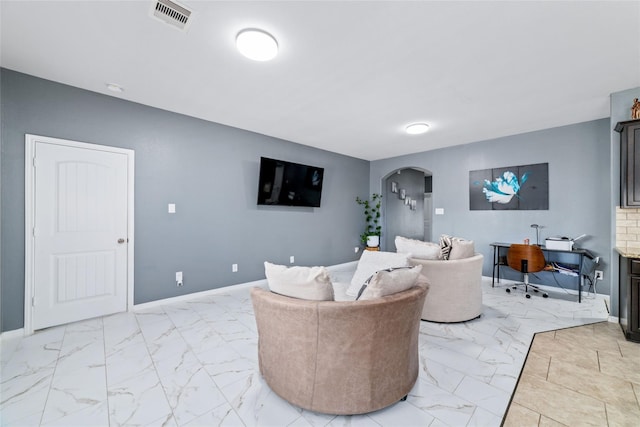 3319 Mcdonough Way, Katy, TX 77494 - living area featuring arched walkways, light marble finish flooring, a desk, and baseboards