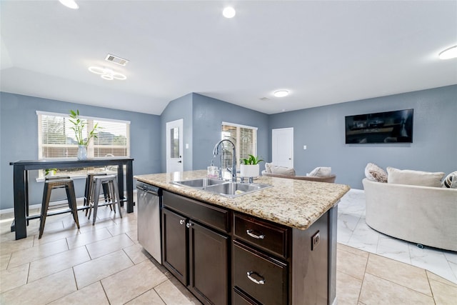 3319 Mcdonough Way, Katy, TX 77494 - kitchen with a sink, stainless steel dishwasher, open floor plan, dark brown cabinetry, and a kitchen island with sink