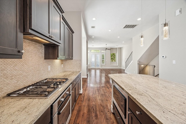 4209 Feagan St, Houston, TX 77007 - kitchen with appliances with stainless steel finishes, dark wood finished floors, light stone counters, tasteful backsplash, and recessed lighting