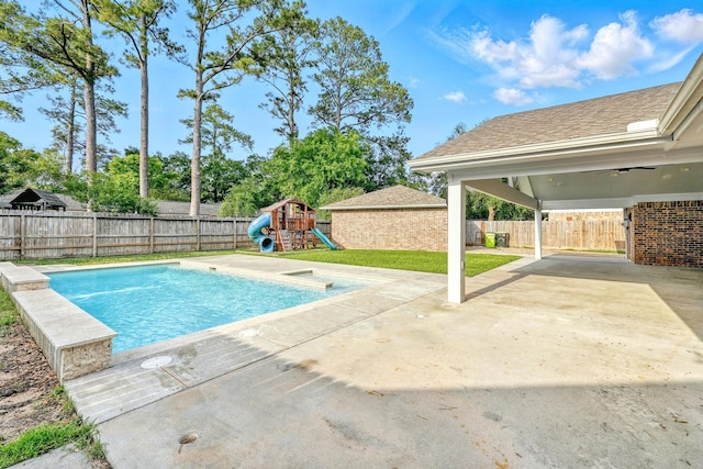 12318 Amado Dr, Houston, TX 77065 - view of pool with a patio, a playground, and a fenced backyard
