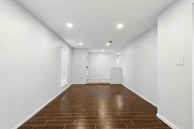 12318 Amado Dr, Houston, TX 77065 - empty room with dark wood finished floors, recessed lighting, and baseboards
