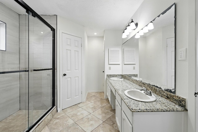 12318 Amado Dr, Houston, TX 77065 - full bath featuring a stall shower, tile patterned floors, double vanity, and baseboards