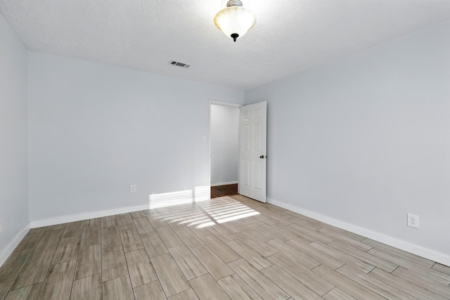 12318 Amado Dr, Houston, TX 77065 - spare room with wood finished floors, a textured ceiling, and baseboards